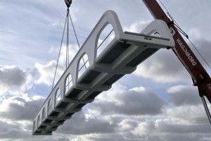 Prefabricated foot bridge being lowered in place